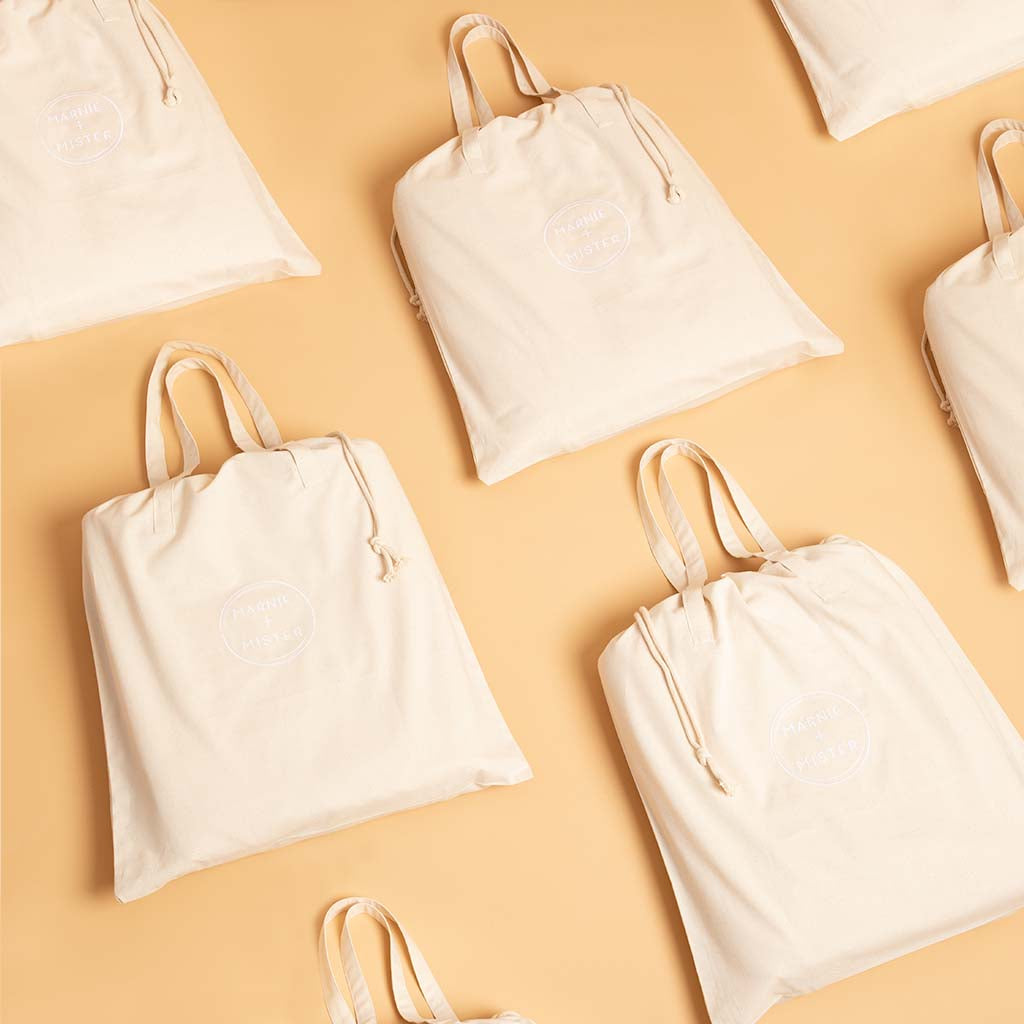 cotton play mats in tote bags on neutral background